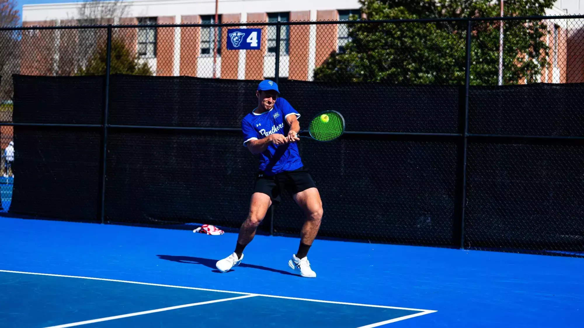Cem Atlamis striking a forehand on a Panthers home court